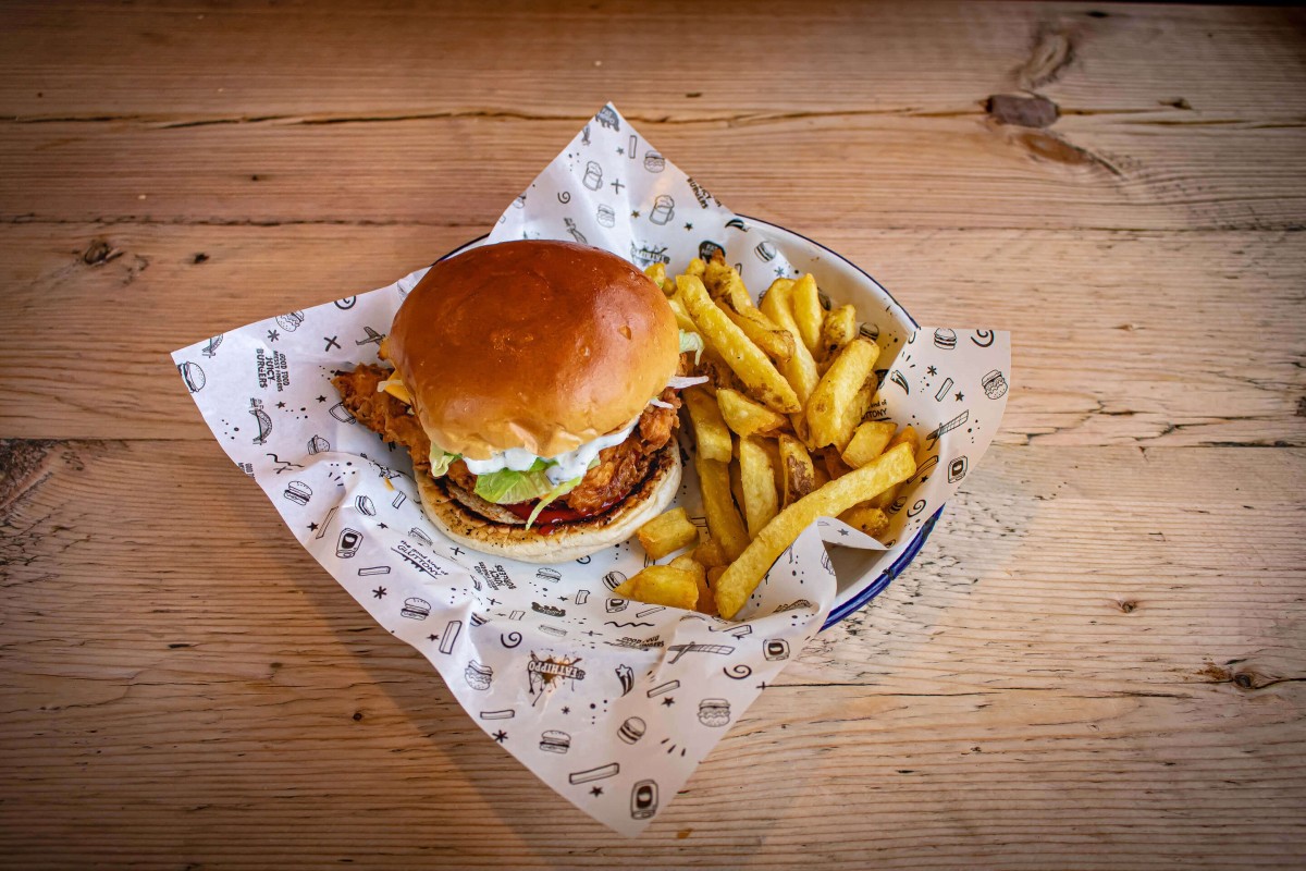 An image of a burger and chips